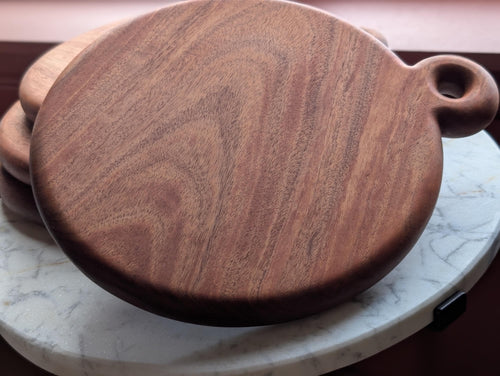 Stack of round cherry cutting boards, fresh batch
