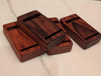 Four bidding boxes stacked, card slots visible